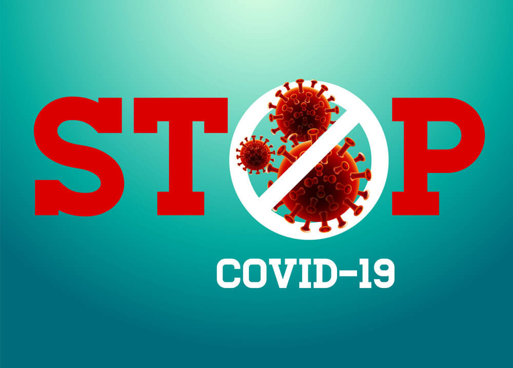 Stop sign with crossed out virus and covid-19 inscription