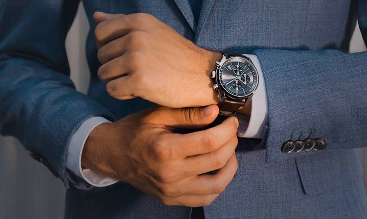 A wristwatch and a man in a suit